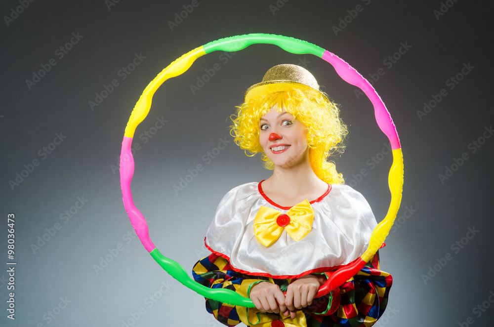 Clown in funny concept on dark background