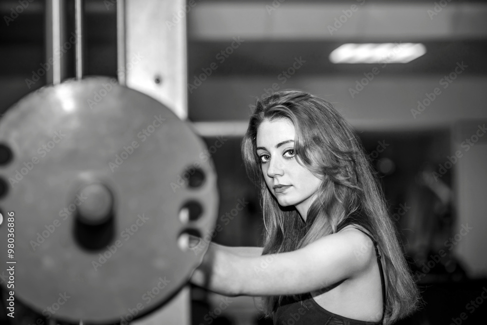 Fototapeta premium Young pretty girl work out in the gym