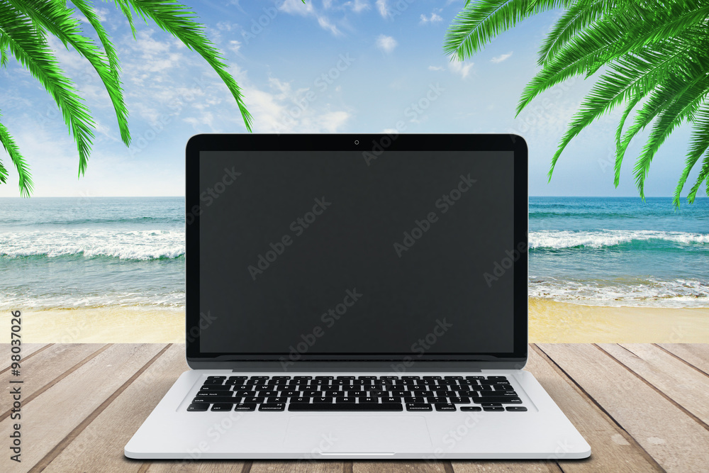 Blank black laptop screen on wooden bench on the beach, mock up Blank black laptop screen on wooden bench on the beach, mock up