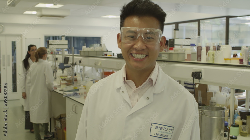 Portrait of young Asian scientist with science team in lab Portrait of young Asian scientist with science team in lab