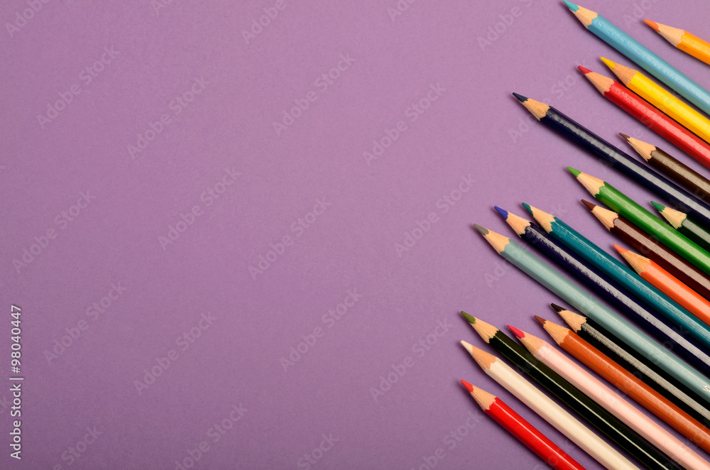 Colorful pencils on purple background Colorful pencils on purple background