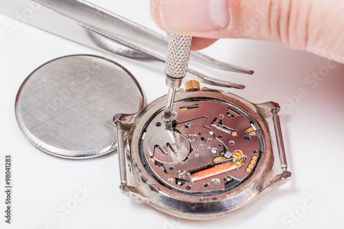 watchmaker replaces battery in quartz watch