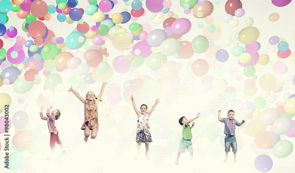 Fototapeta premium Playful children catch balloons
