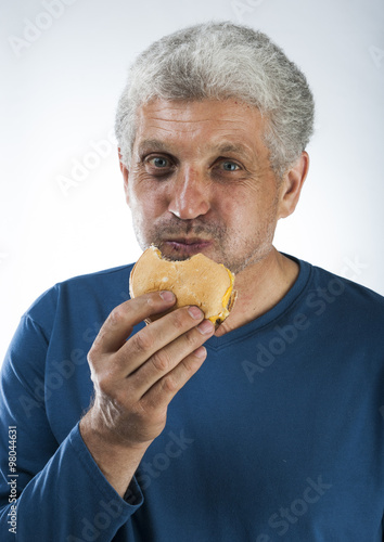 Ugly bum man eating hamburger
