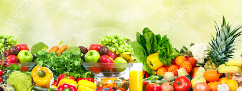Vegetables and fruits over green background. © grinny