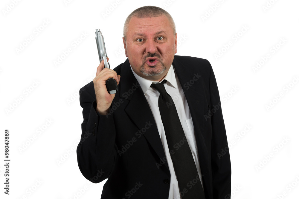 Middle aged businessman pointing gun Middle aged businessman pointing gun