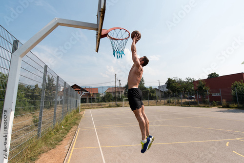 Basketball Player Is About To Slam Dunk © Jale Ibrak