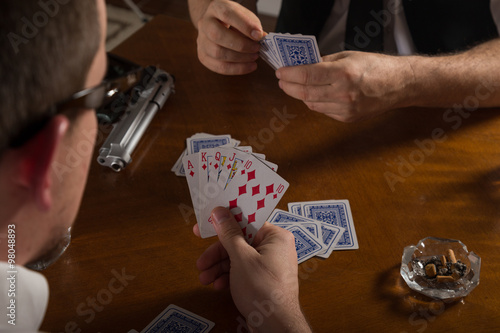 poker cards and handgun