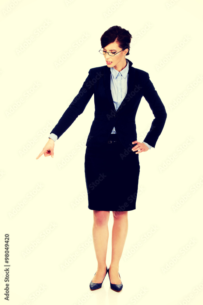 Businesswoman pointing down. Businesswoman pointing down.