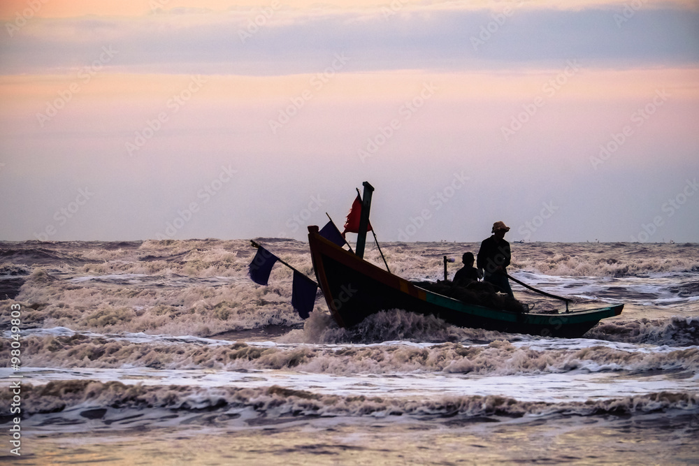 Fishermen fishing in the sea at sunrise in Namdinh, Vietnam