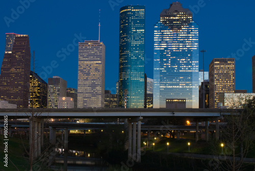 View of the downtown area of Houston from a Buffalo Bayou park at night.  