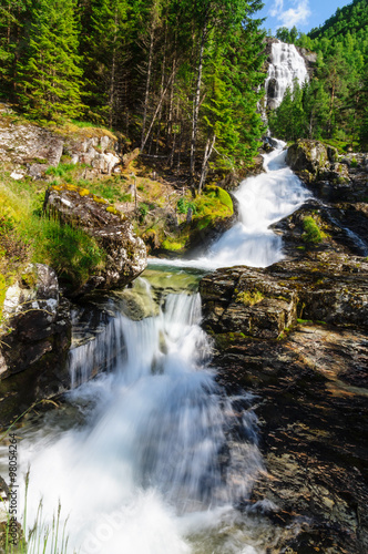 Fototapeta Naklejka Na Ścianę i Meble -  High waterfall in the summer woods