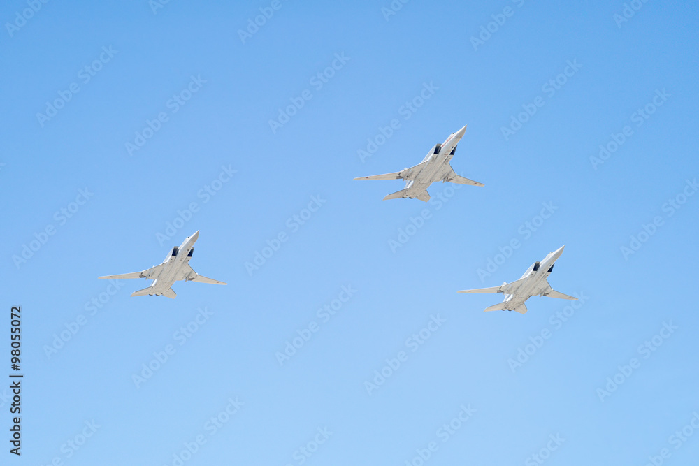 Tupolev Tu-22M3 (Backfire) supersonic swing-wing long-range strategic and maritime strike bombers fly against blue sky background Tupolev Tu-22M3 (Backfire) supersonic swing-wing long-range strategic and maritime strike bombers fly against blue sky background