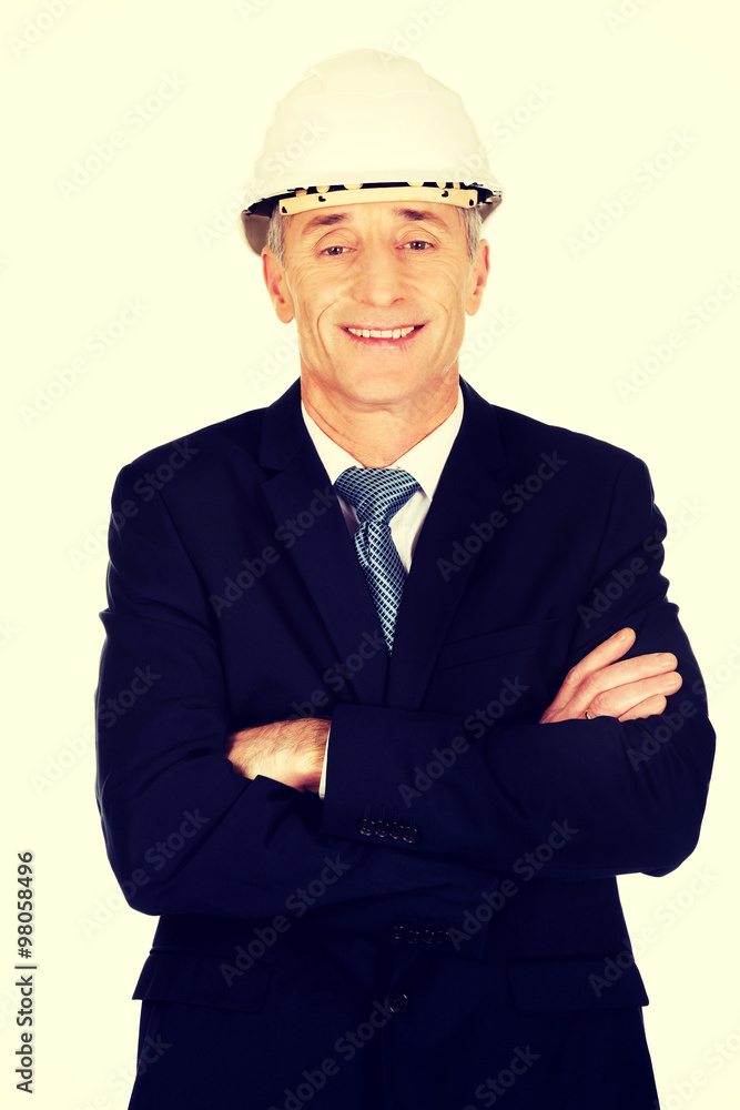 Smiling businessman with hard hat Smiling businessman with hard hat