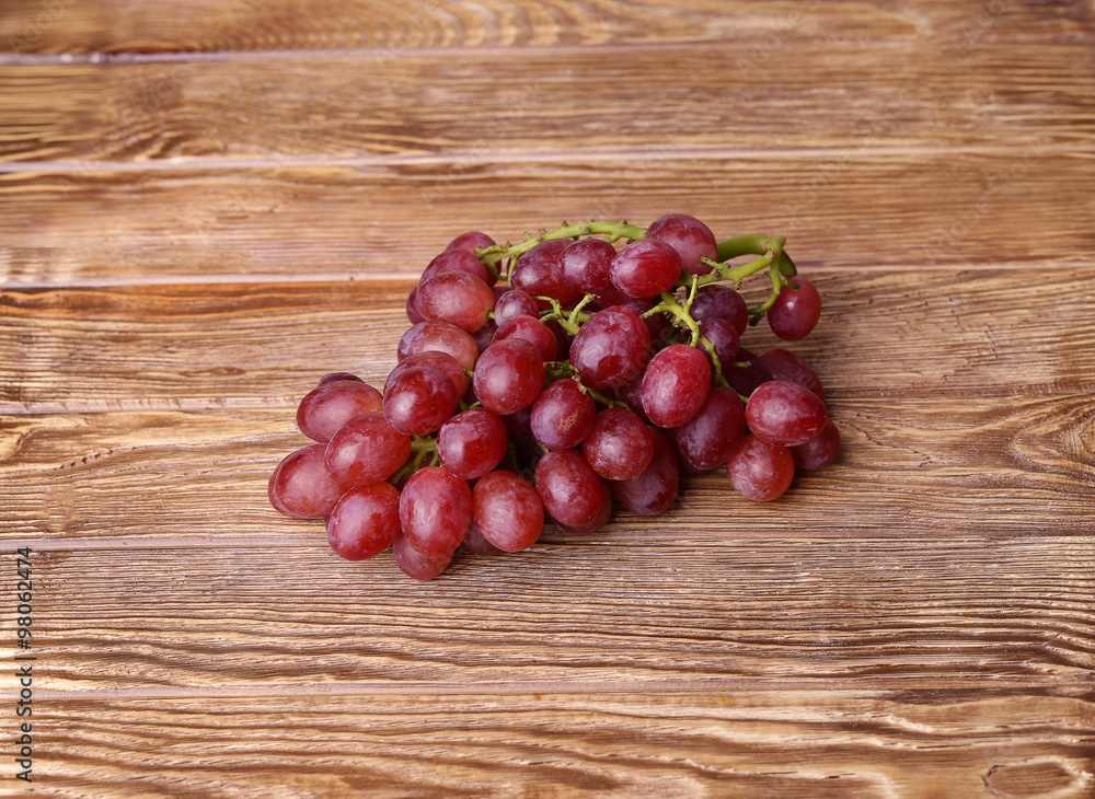 red grapes on wooden table background red grapes on wooden table background