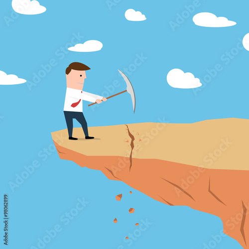 Man on a cliff edge digging the ground