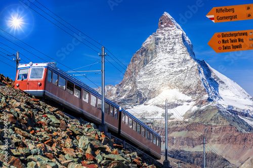 Matterhorn with Signpost against train in Swiss Alps