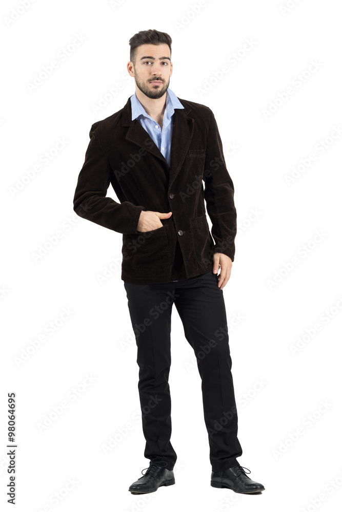 Fashion model in corduroy jacket looking at camera with hand in pocket. Full body length portrait isolated over white studio background. Fashion model in corduroy jacket looking at camera with hand in pocket. Full body length portrait isolated over white studio background.