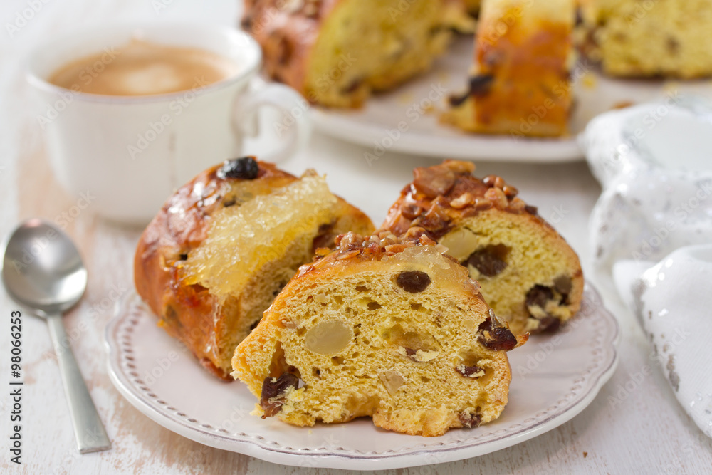 Christmas portuguese cake with dry fruits on white plate with cup of coffee Christmas portuguese cake with dry fruits on white plate with cup of coffee