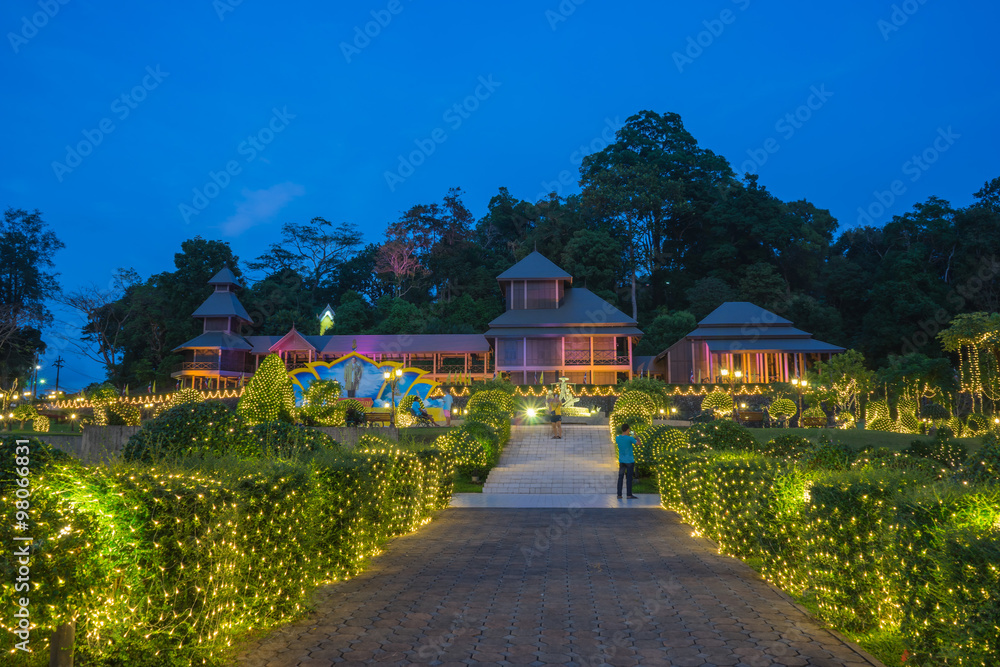 Naklejka premium RANONG PROVINCE, THAILAND-Dec 13:People take a photo at the fifth king's throne reproduce and mining statue on Dec 13, 2015 in Ranong Province, Thailand. Light decor for November and December.