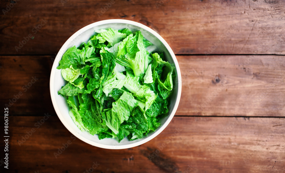..Fresh Green salad in a white bowl on rustic background with co ..Fresh Green salad in a white bowl on rustic background with co