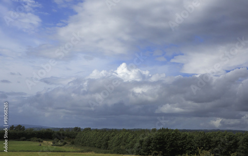 Beautiful blue sky with storm clouds over countryside in Ireland