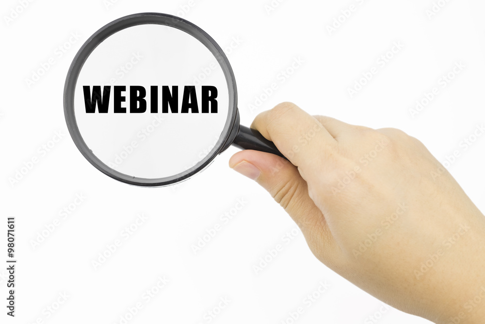 Hand showing WEBINAR word through magnifying glass Hand showing WEBINAR word through magnifying glass