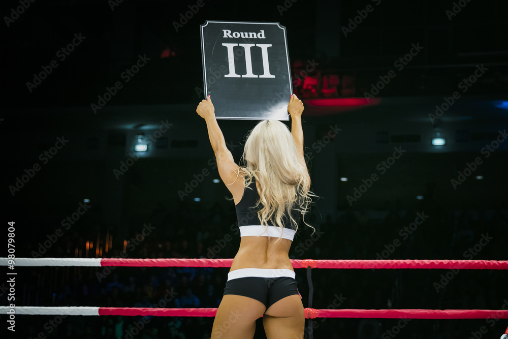 beautiful sexy girl in ring during competition in MMA and Boxing. in his  hands sign with round number Stock Photo | Adobe Stock