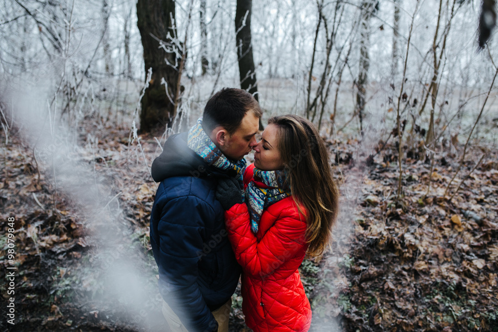 couple walking on a winter park couple walking on a winter park