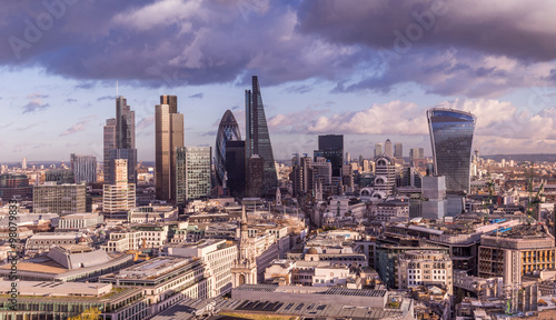 Skyline of Business district of London with dark clouds and Canary Wharf at the background