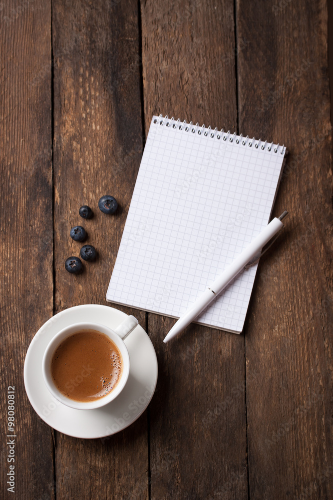 Notebook and coffee with copy space on a wooden background. selective focus. Notebook and coffee with copy space on a wooden background. selective focus.