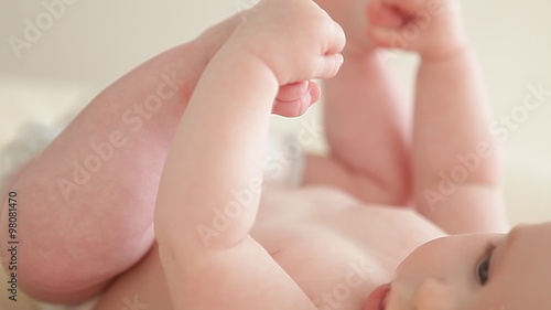 little baby playing with the feet