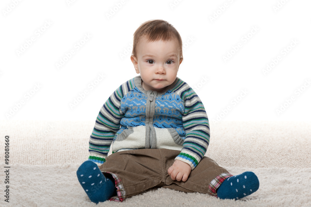 Fashion baby boy sit on the white carpet Fashion baby boy sit on the white carpet