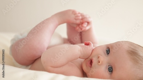 little baby playing with the feet