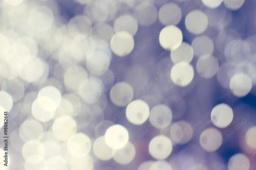 Fototapeta premium Light blurred background with white bokeh lights on it. Festive holiday theme with copyspace