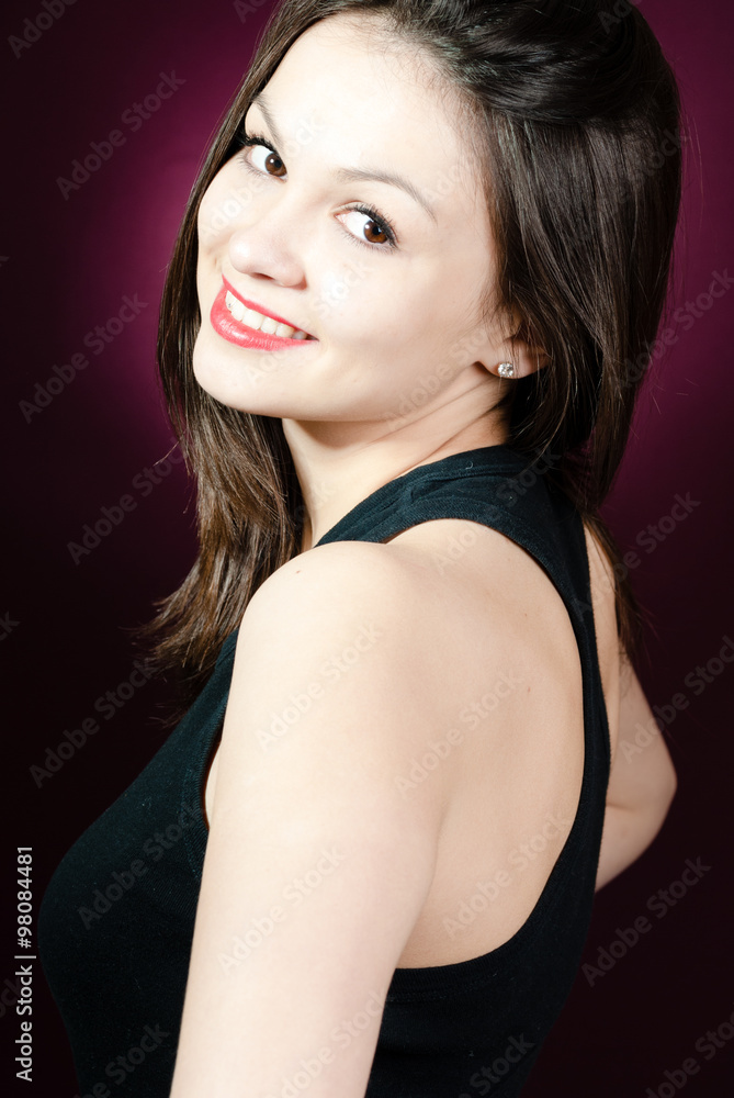 Fototapeta premium Smiling woman looking over shoulder