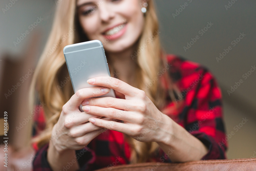 Content cheerful blonde girl using cellphone Content cheerful blonde girl using cellphone