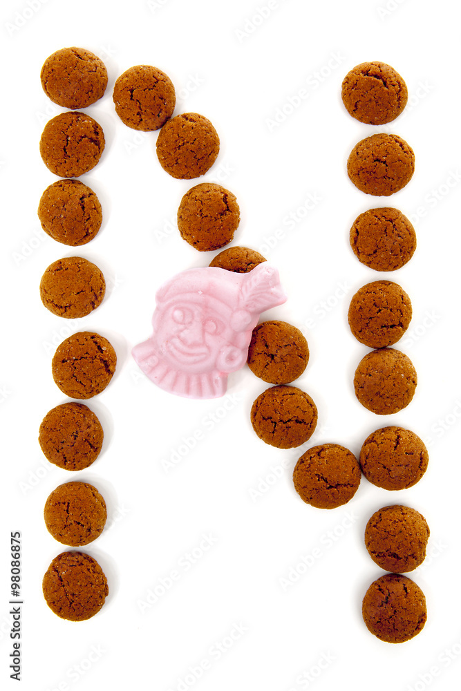 Ginger nuts, pepernoten, in the shape of letter N isolated on wh Ginger nuts, pepernoten, in the shape of letter N isolated on wh