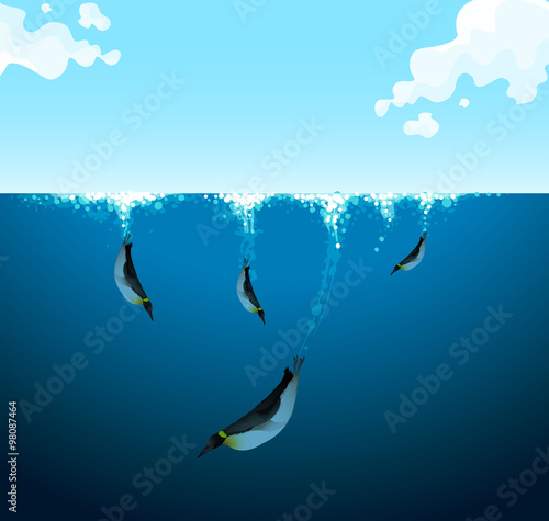 Penguins swimming under the ocean