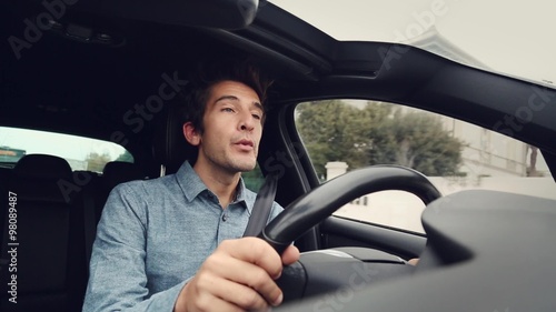 Happy man whistling driving car
