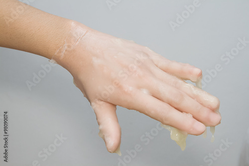 Wallpaper Mural woman's hand bathing in paraffin or wax , Hand and nail spa