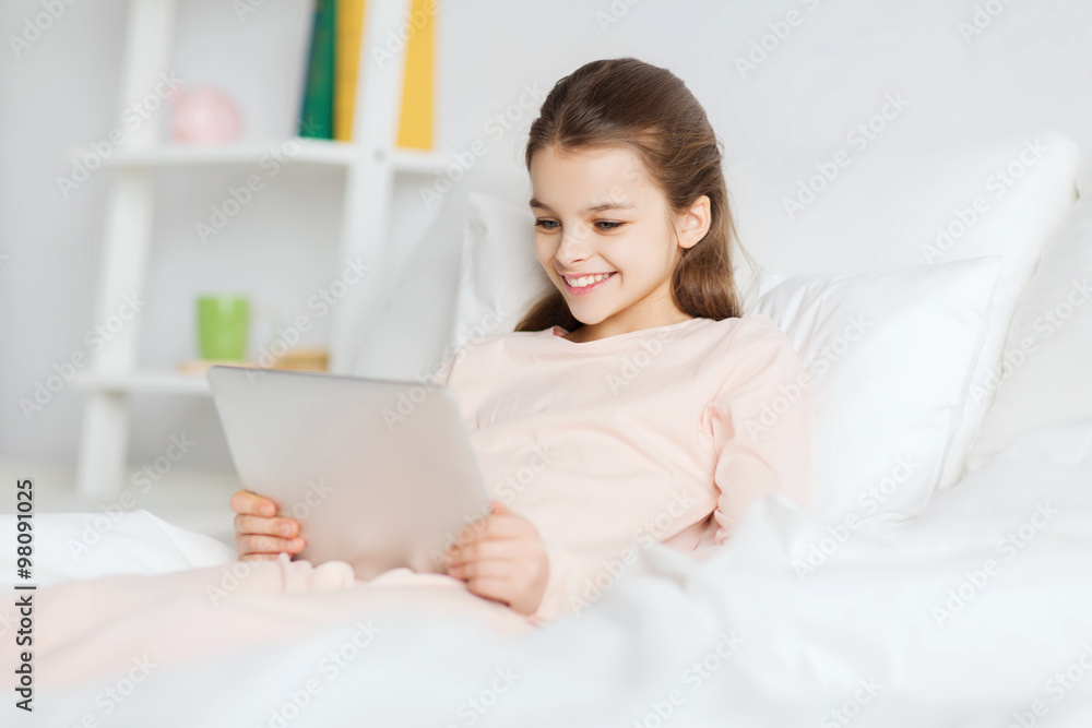 happy girl lying in bed with tablet pc at home happy girl lying in bed with tablet pc at home