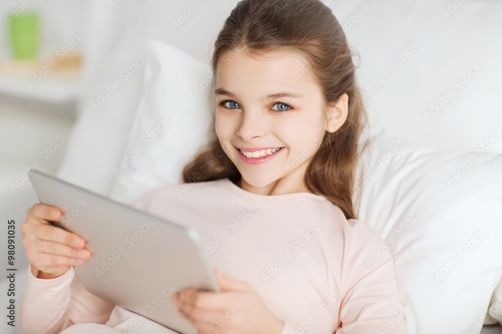 happy girl lying in bed with tablet pc at home happy girl lying in bed with tablet pc at home