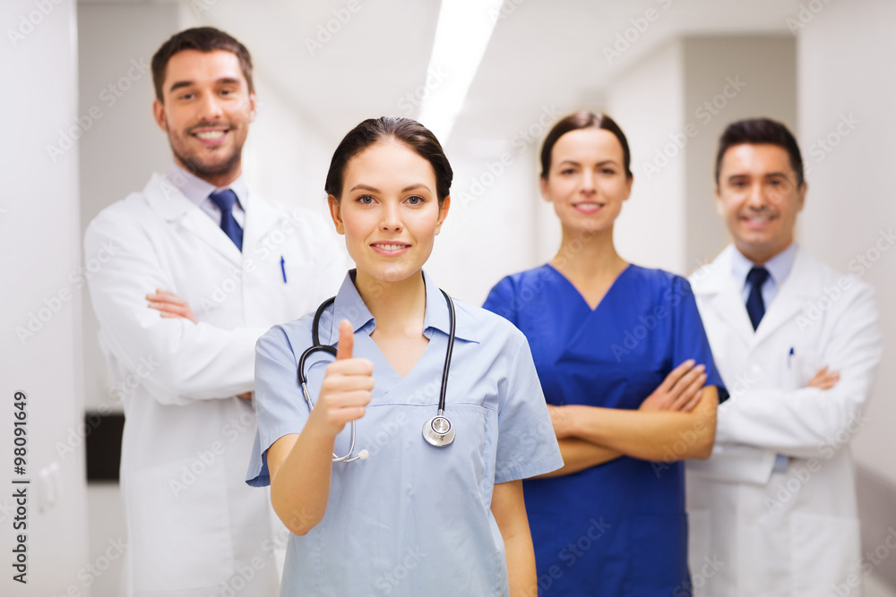 medics or doctors at hospital showing thumbs up medics or doctors at hospital showing thumbs up