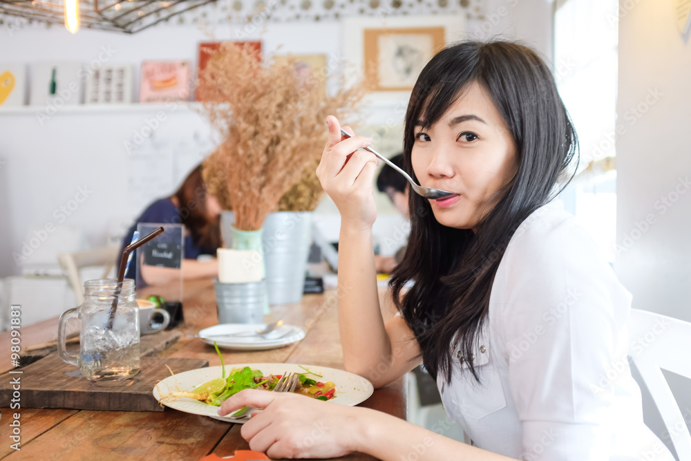 Young business woman on lunch break in restaurant
