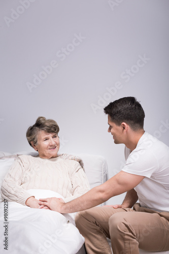 Man helping his ill grandmother