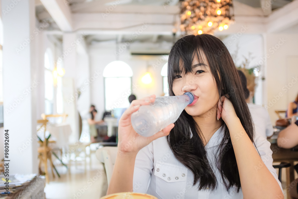 Portrait of young beautiful asian woman drinking water Portrait of young beautiful asian woman drinking water