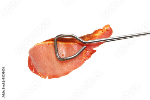 Obraz na płótnie Bacon rasher in tongs