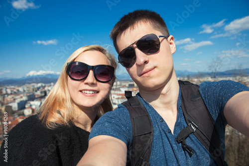 Happy couple traveling at the city and making selfie