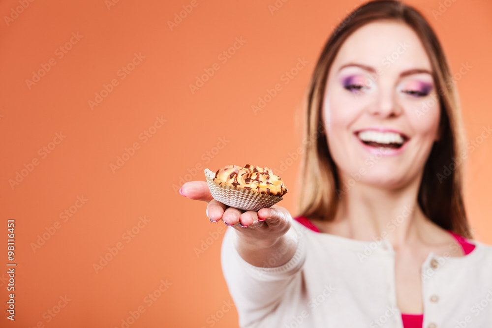 Woman holding delicious sweet cupcake. Gluttony. Woman holding delicious sweet cupcake. Gluttony.